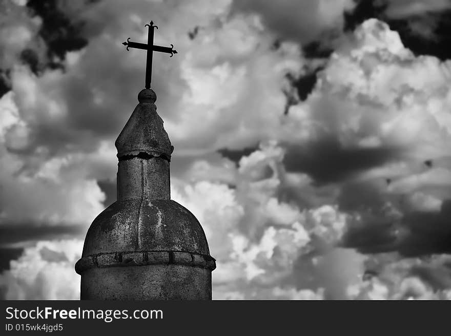 Black and white religious monument against a cloudy sky