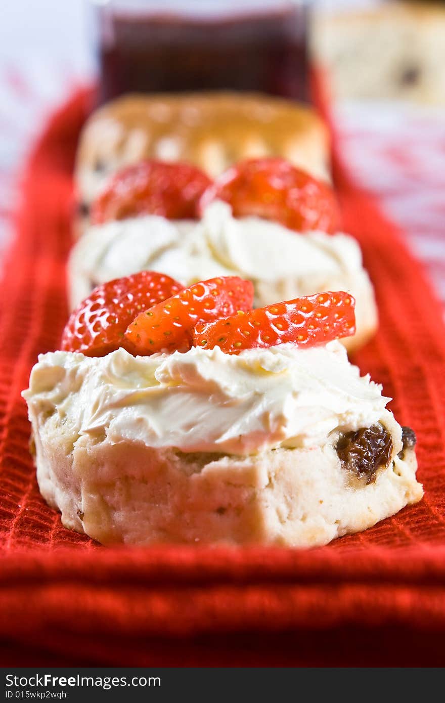 A Line Of Scone Halves With Strawberries