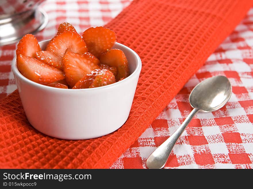 Fresh sliced strawberries in a white pot