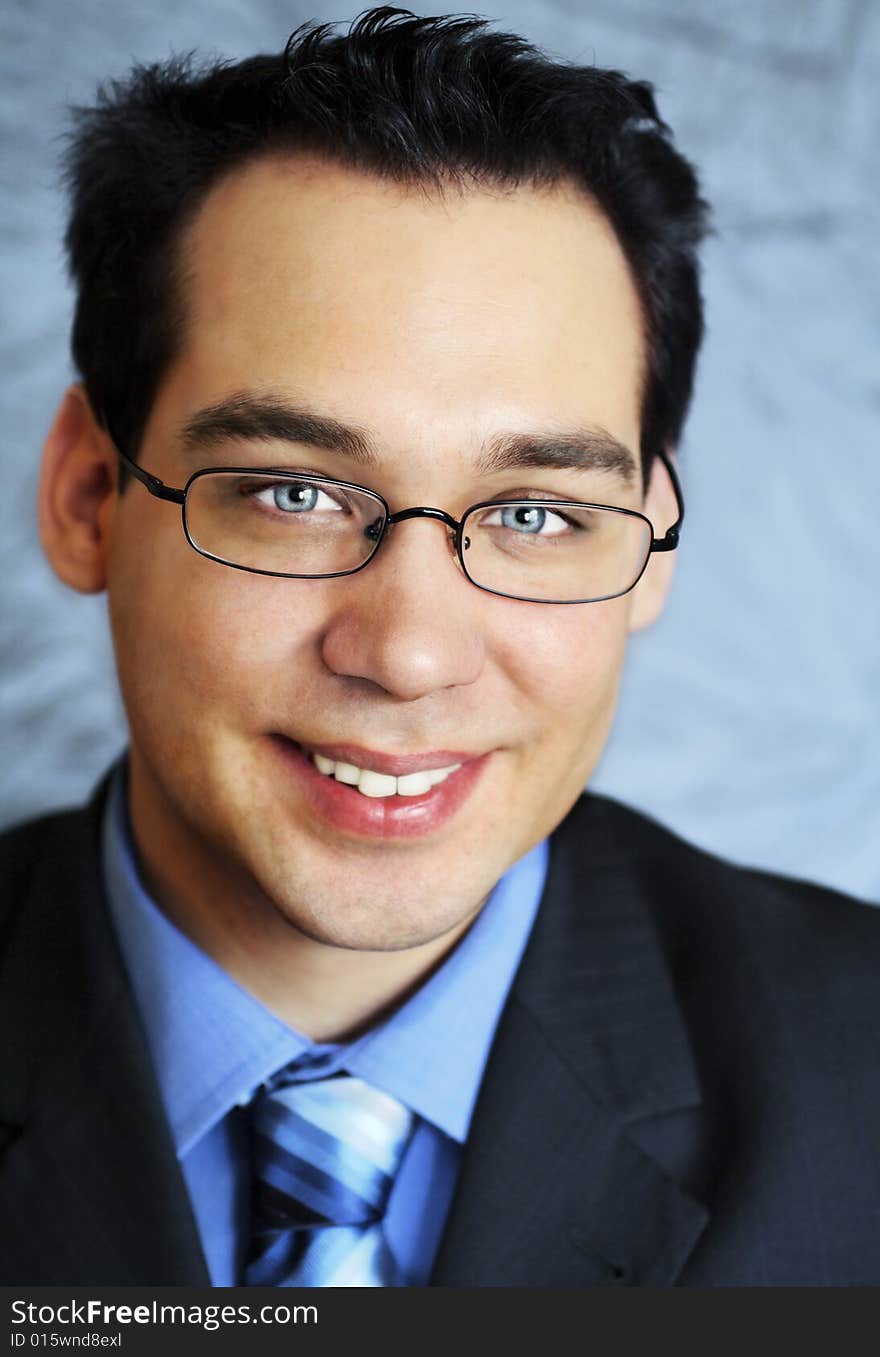 Young business man with glasses, looking smiling at camera. Young business man with glasses, looking smiling at camera