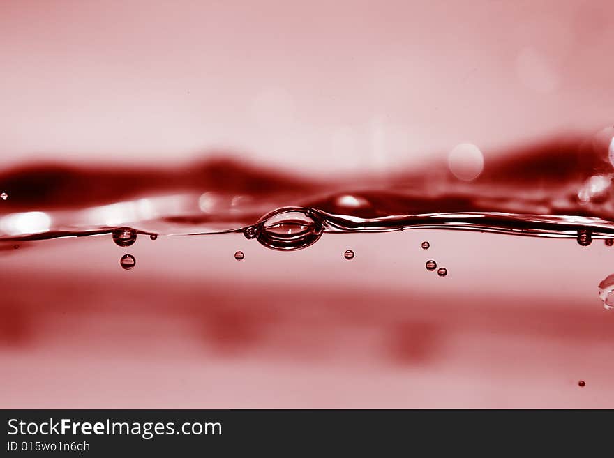 Red water in motion with bubbles, perfect for background