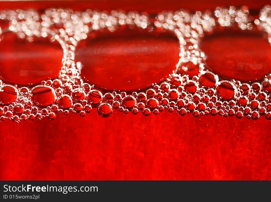 Red bubbles water under glass bottle, actually its some rose wine in a bottle,  macro, shallow DOF