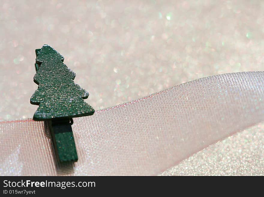 Christmas tree peg on ribbon with glitter sparkles dust background , super macro, shallow DOF