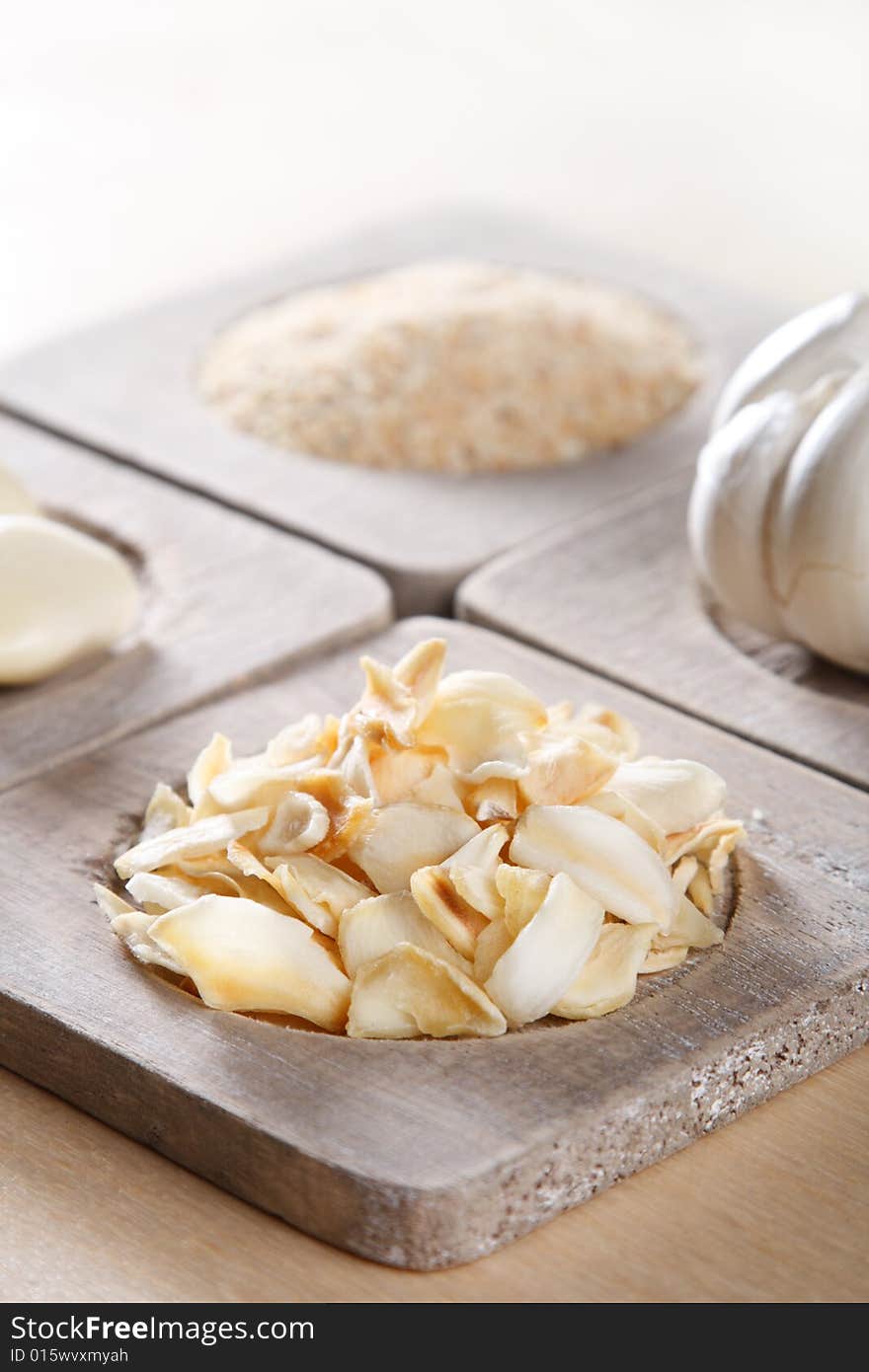 Garlic  flakes  old wooden plates, shallow DOF