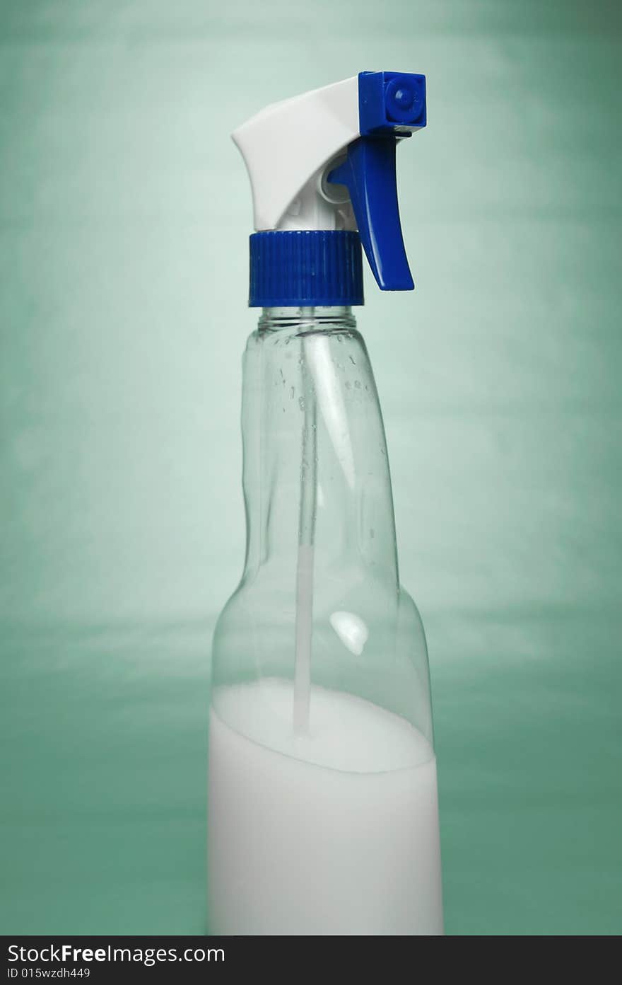 Cleaning products isolated against a green background