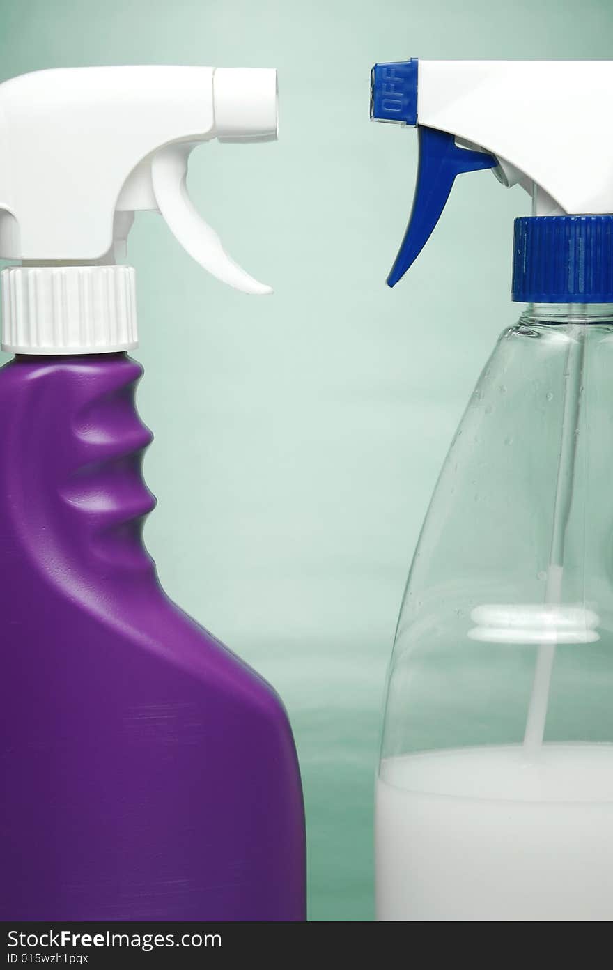 Cleaning products isolated against a green background