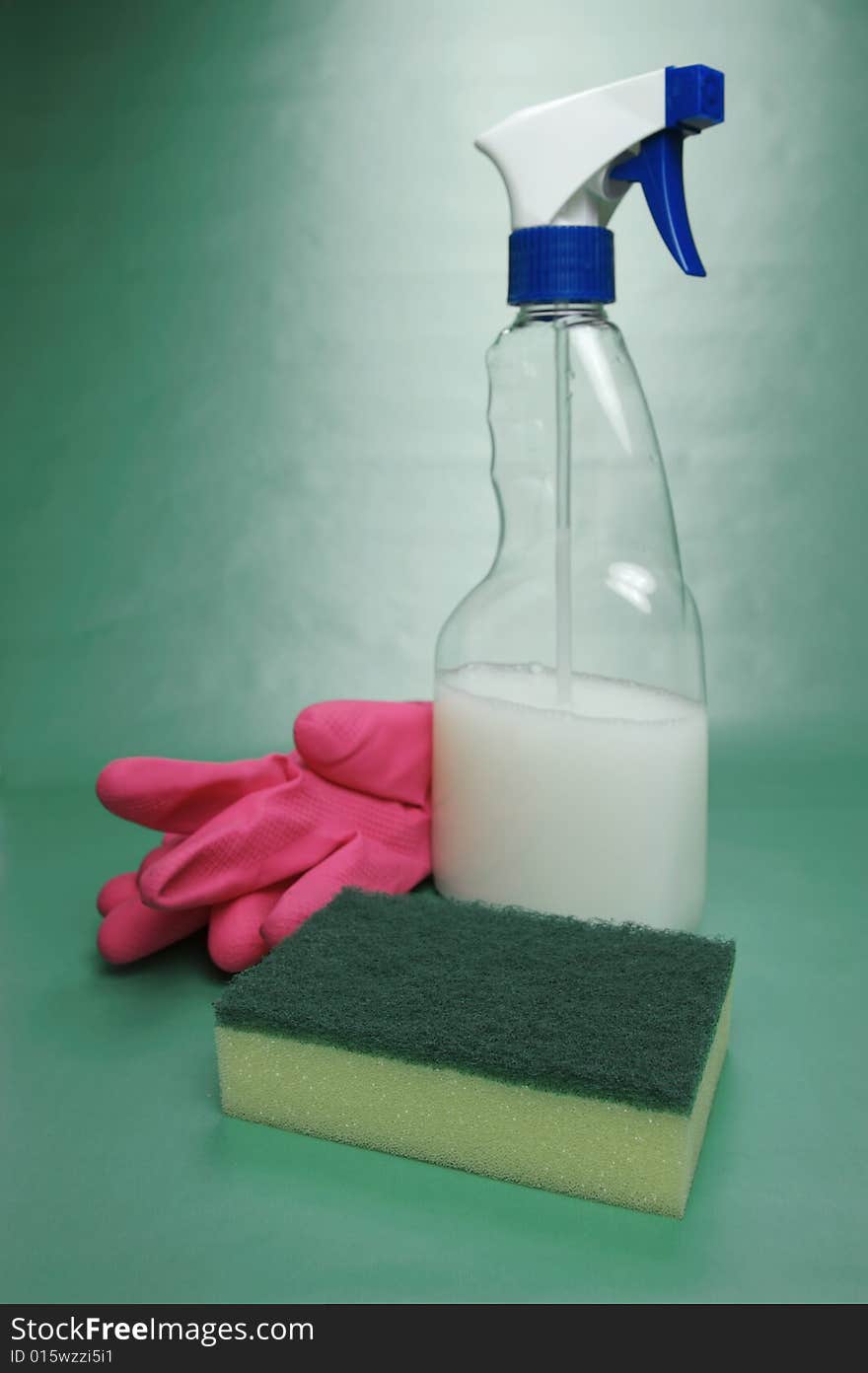 Cleaning products isolated against a green background