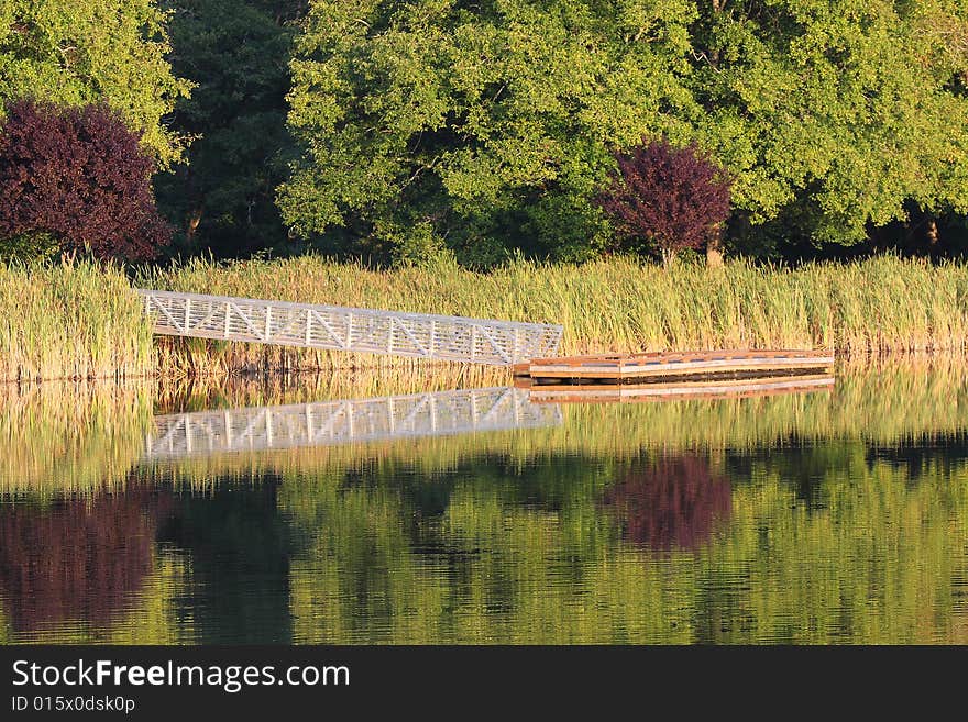 Summertime reflections on the bridge to the fishing dock