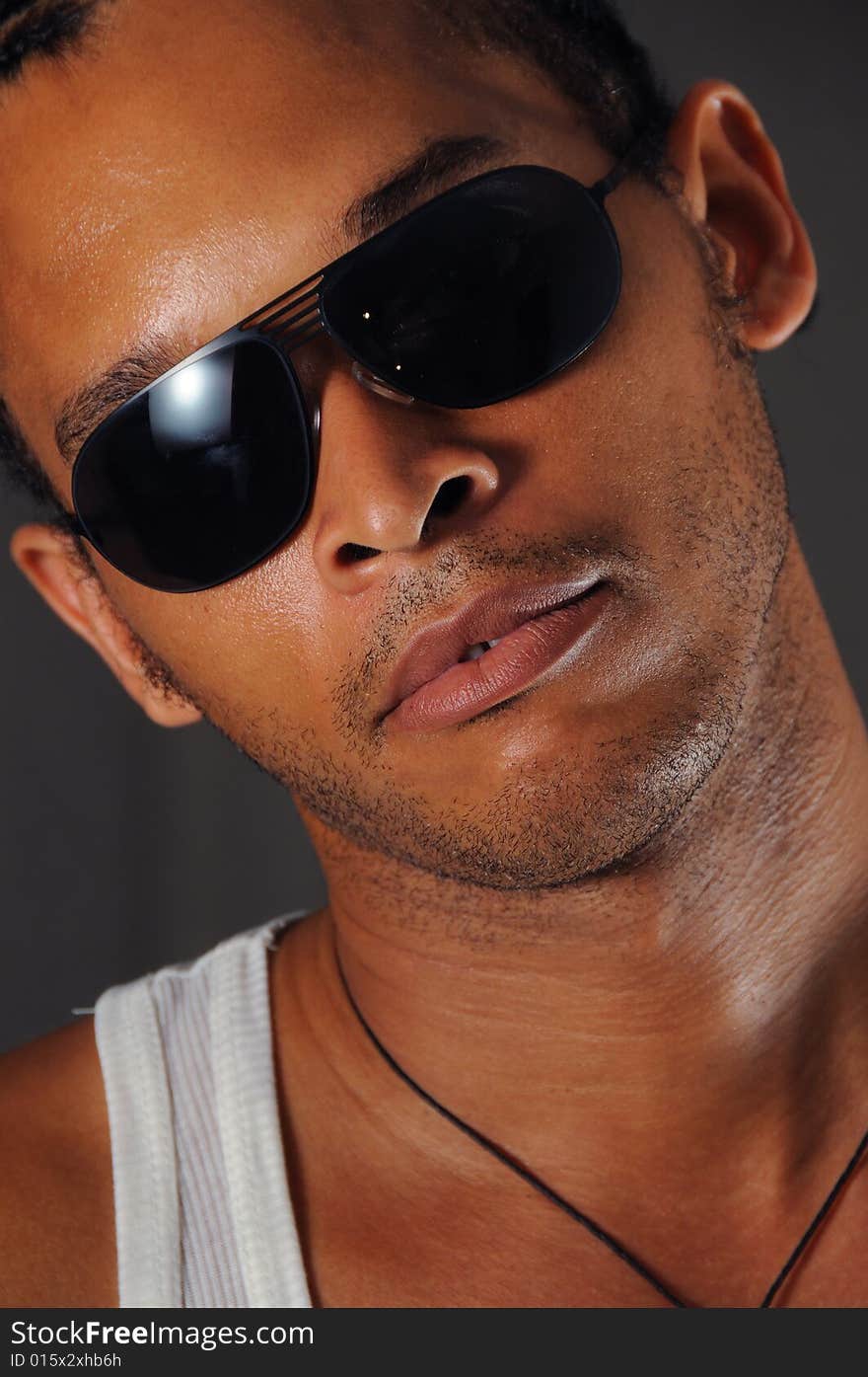 Portrait of young trendy african man with sunglasses