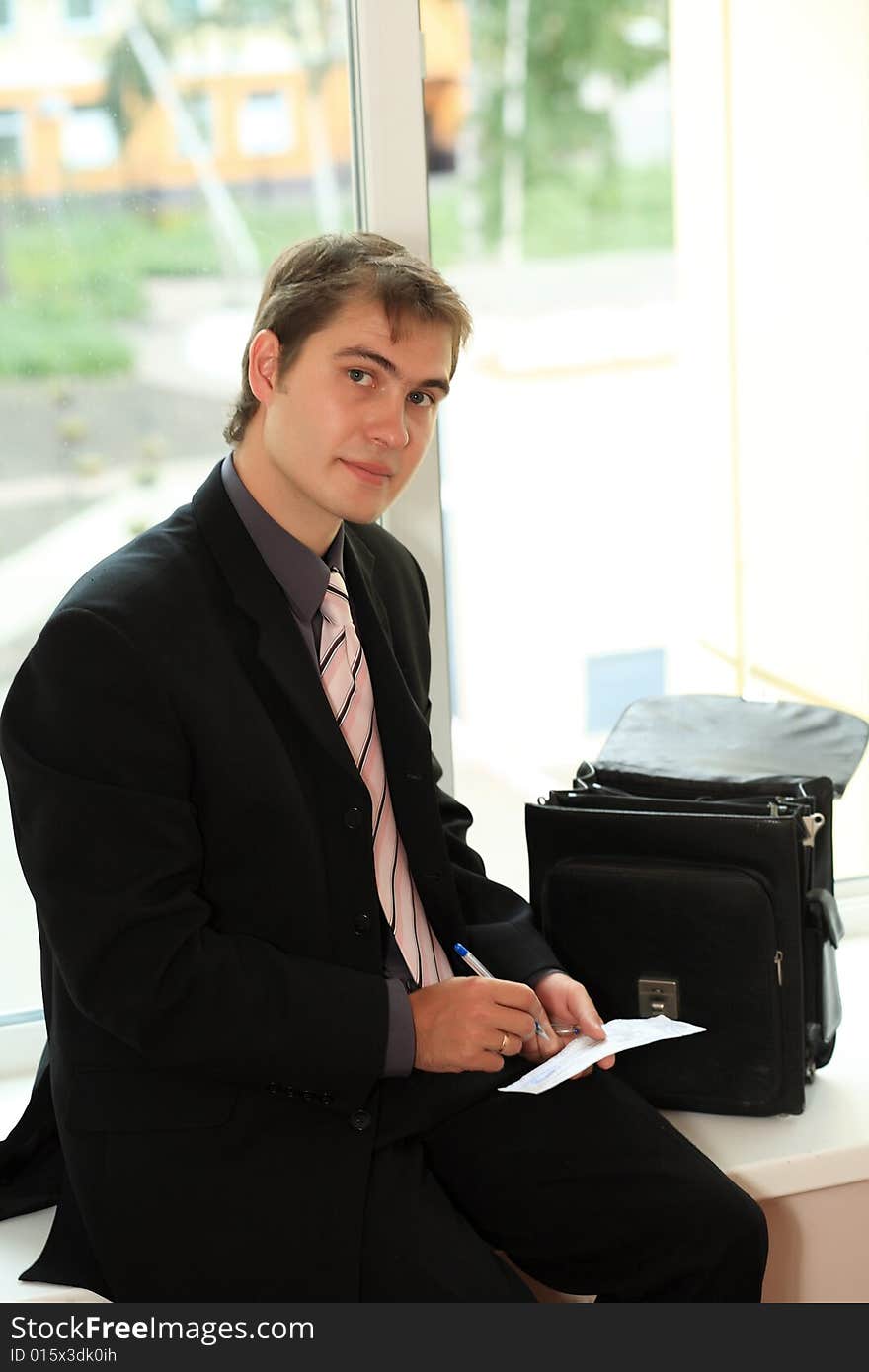 Business background: handsome businessman in a work process. Business background: handsome businessman in a work process.