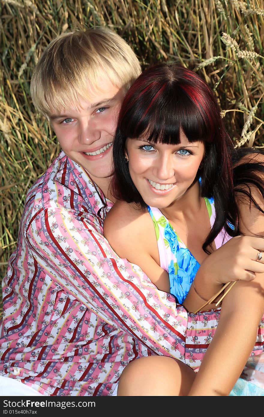 Beautiful couple lying on the grass. Beautiful couple lying on the grass