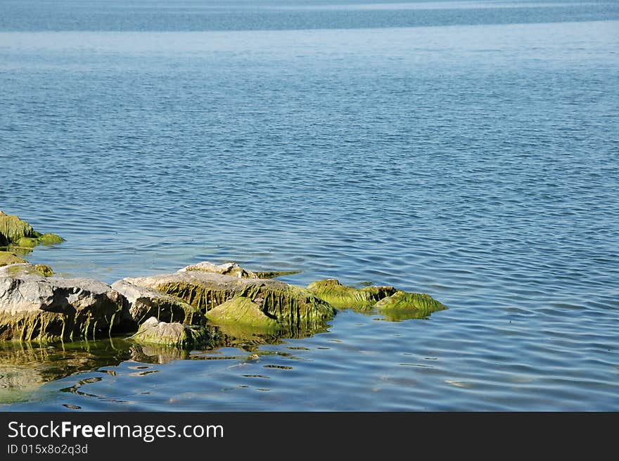 Er Hai,No.7 tableland lake of China,located at Dali city, Yunnan province, blue water,green float grass,brown rock, breeze,ripple.