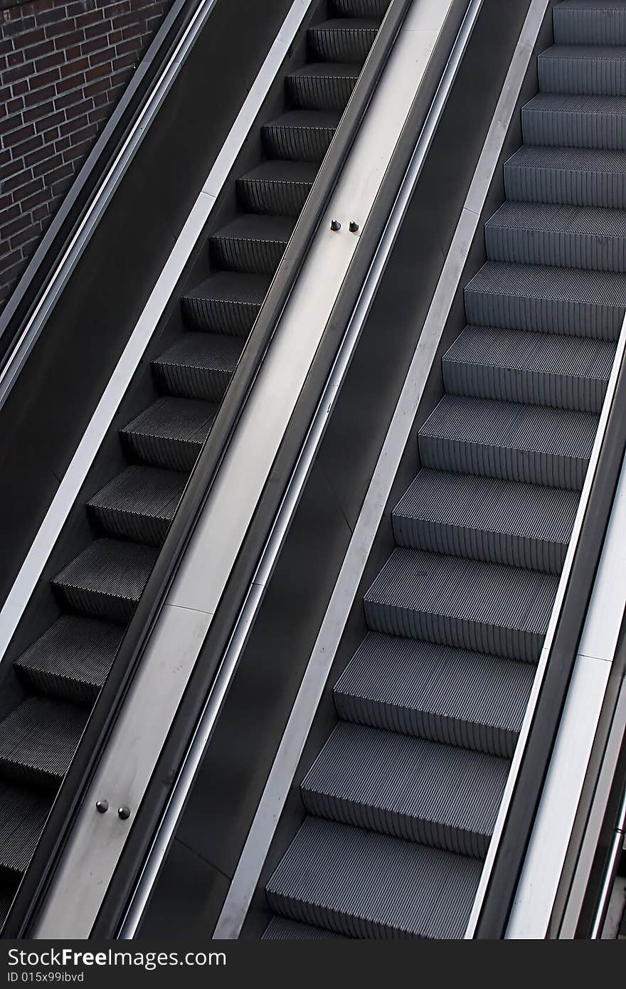 A pair of escalators in underground entrance.