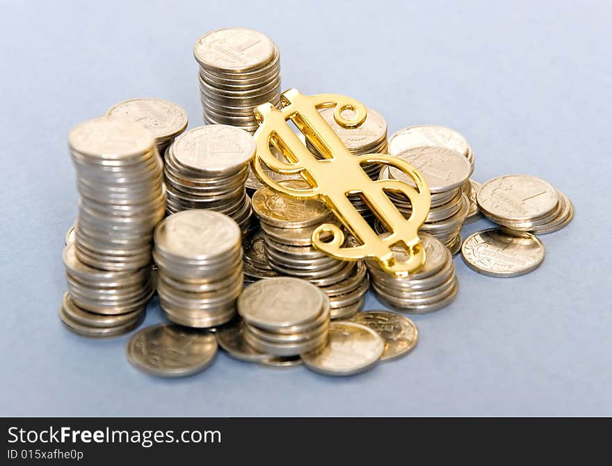 Small silver coins with golden dollar sign. Small silver coins with golden dollar sign