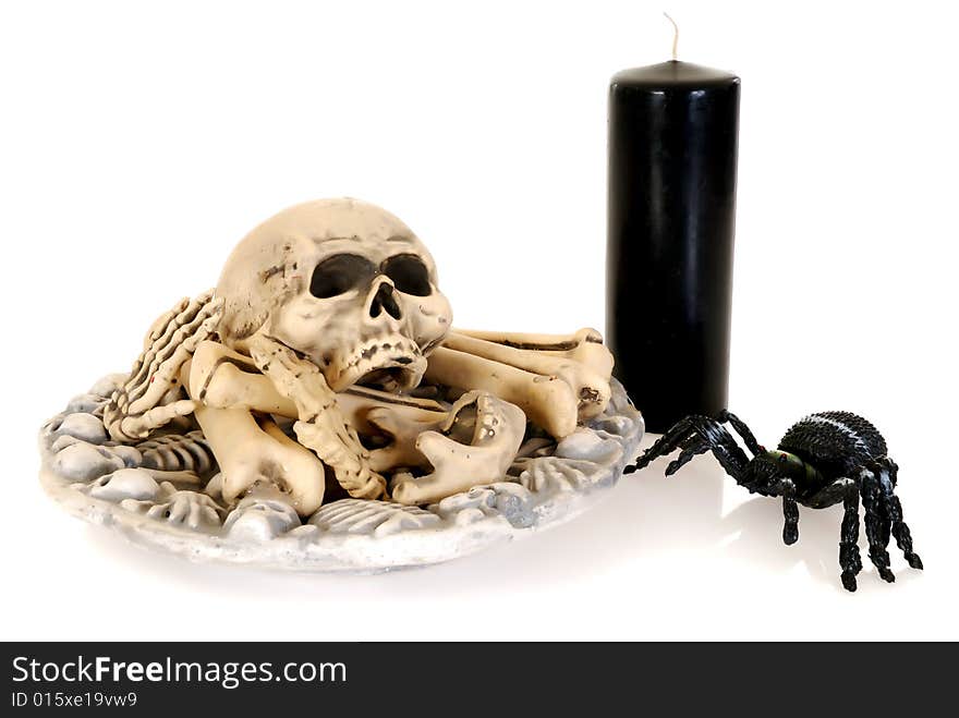 Halloween, fun and creepy, skull and bones with spider and candle on white background