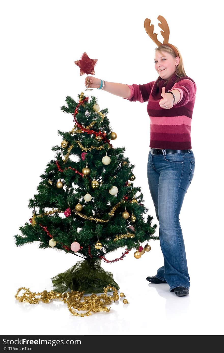 Happy girl decorating Christmas tree