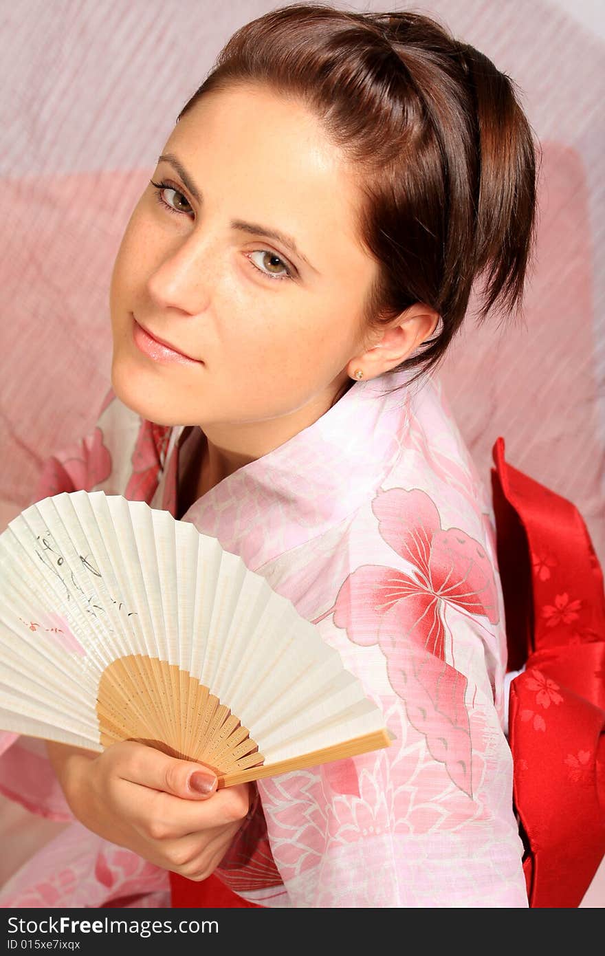 A photograph of a young girl wearing pink yukata. A photograph of a young girl wearing pink yukata.