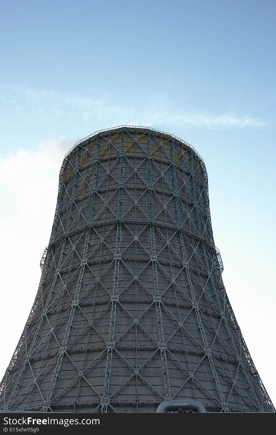 The evaporating cooling tower against the sky. The evaporating cooling tower against the sky