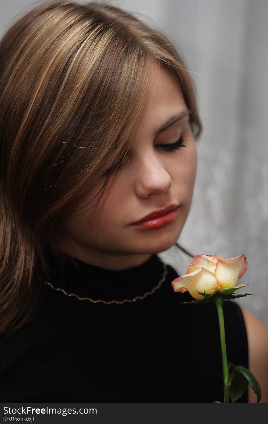 Portrait of young woman with rose