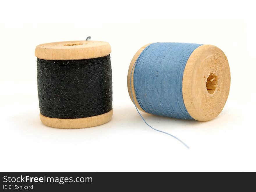 Isolated blue & black spools on white background. Isolated blue & black spools on white background