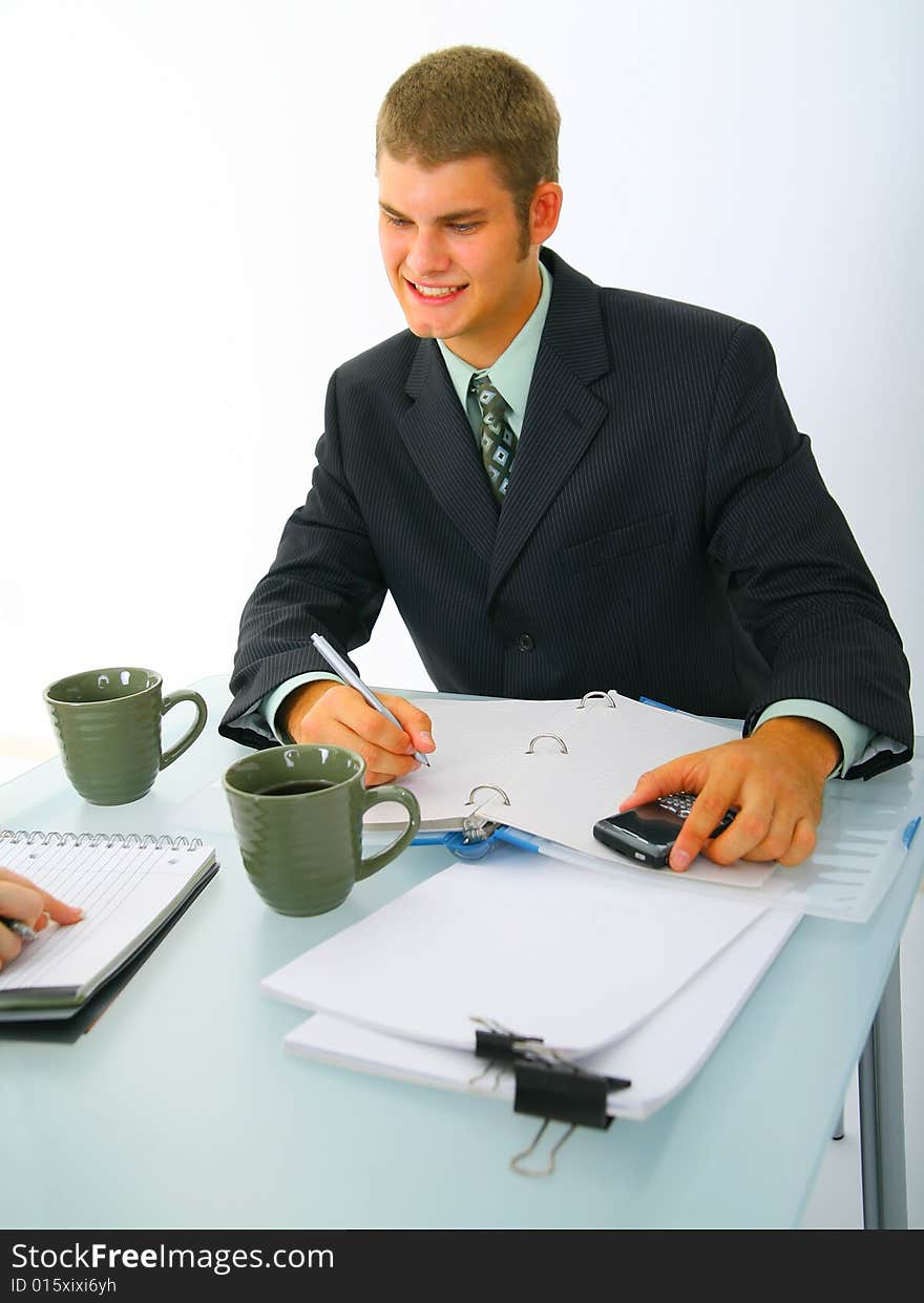 Happy caucasian businessman working and taking note