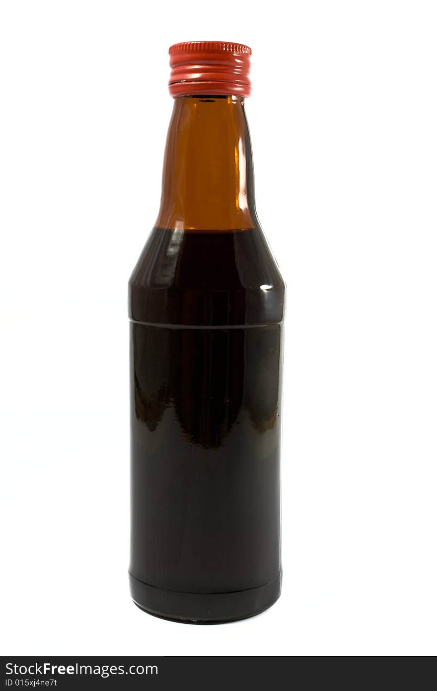 Bottle with a medicine closed by a red cover on a white background