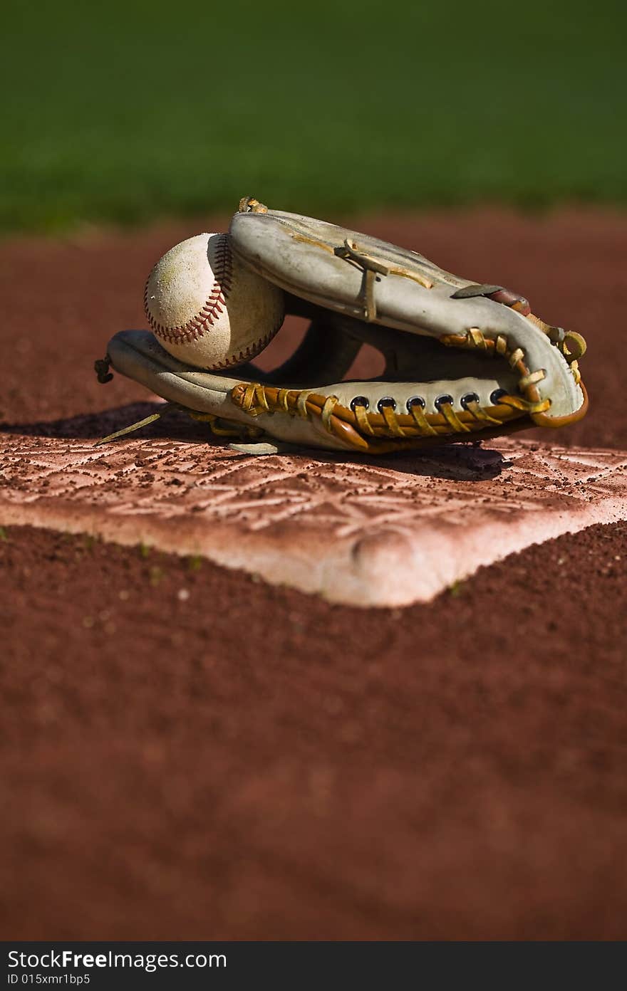 Baseball in glove on the field