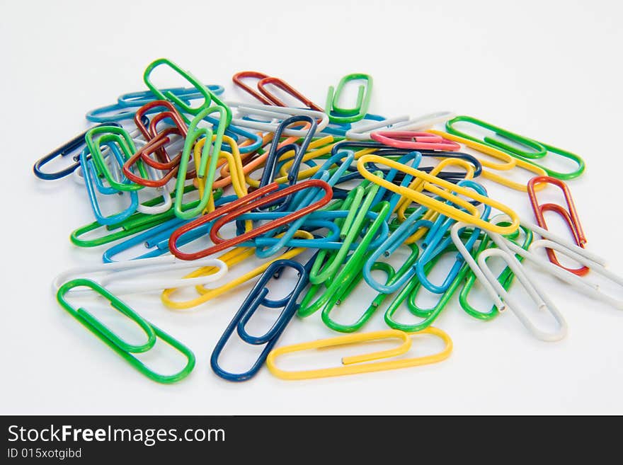 Colored paper-clips on a white background