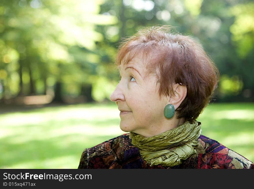 Happy senior woman relaxing in park