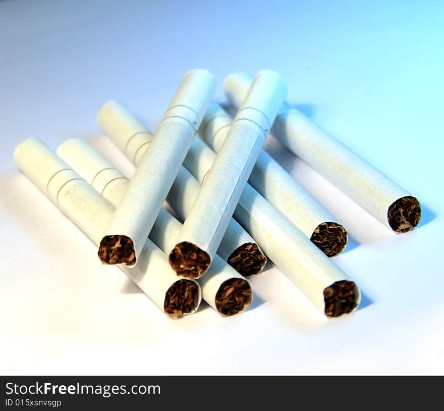 Close-up photo of white cigarettes on blue background