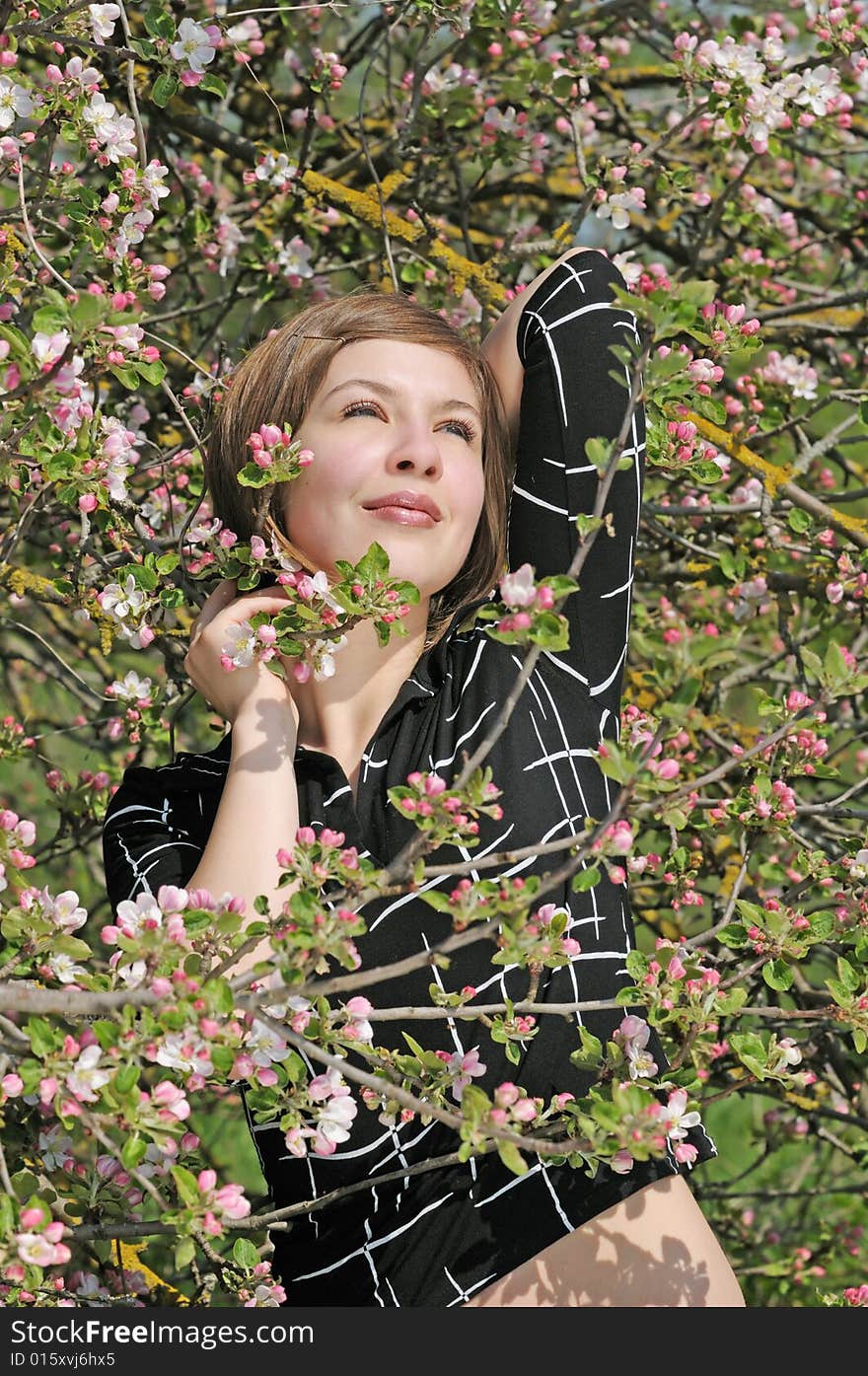 Nice girl on the flowering  apple-tree  background