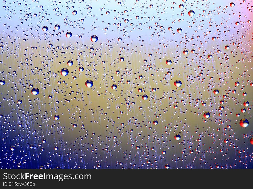 Drops of water on a blue, lila background. Drops of water on a blue, lila background.