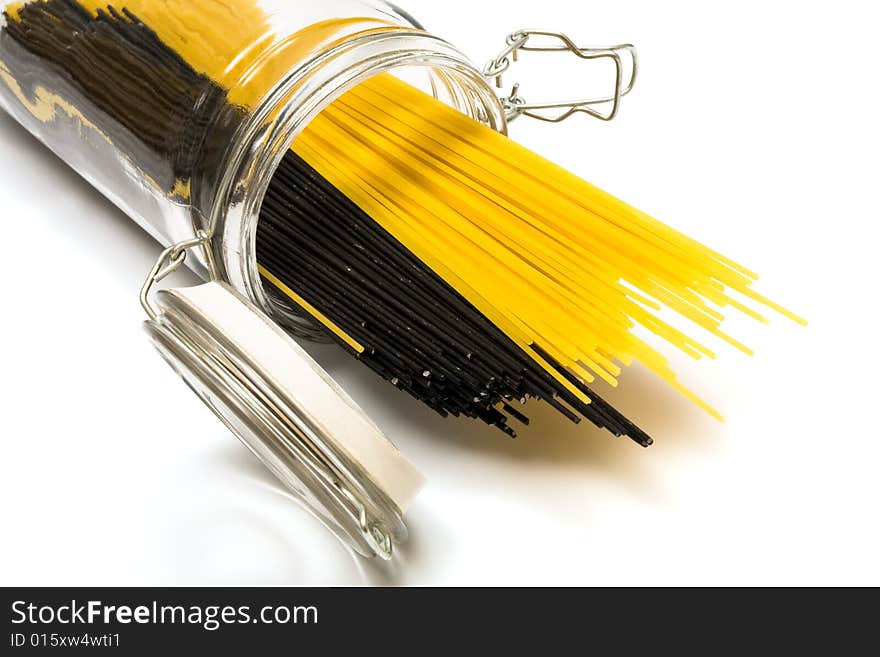 Pasta in glass can on a white background