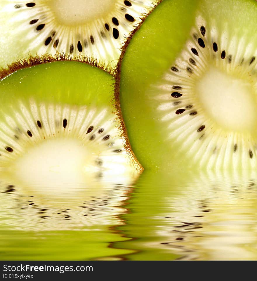 Kiwi slices reflected in water. Kiwi slices reflected in water