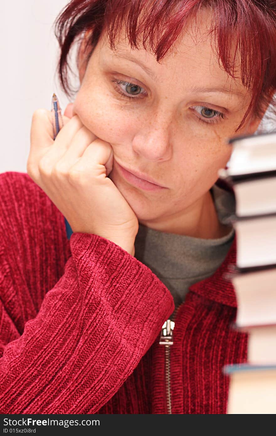 The woman closely studying the literature. The woman closely studying the literature