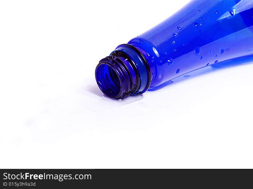 Darkly dark blue bottle with water drops