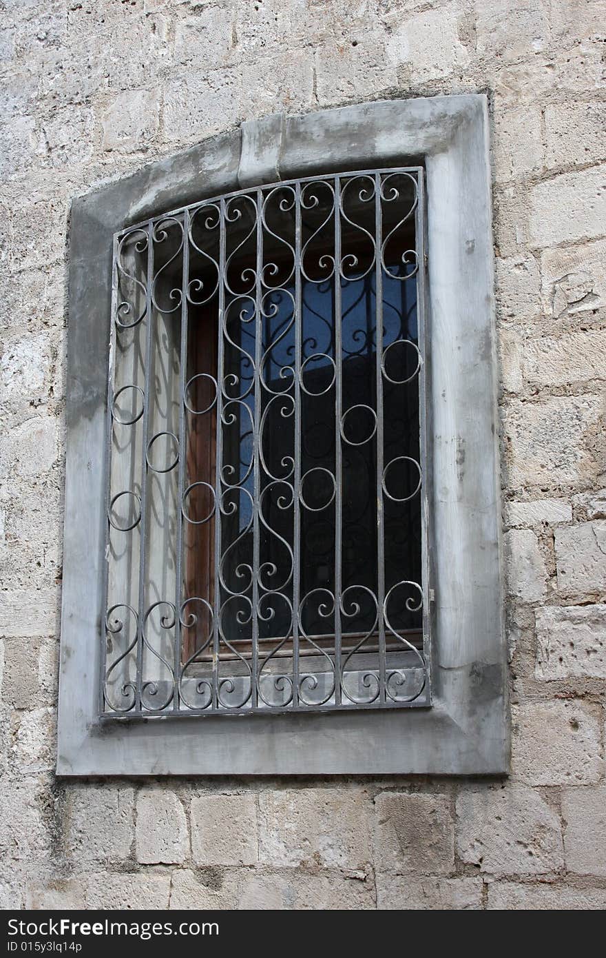 Grated window on old house