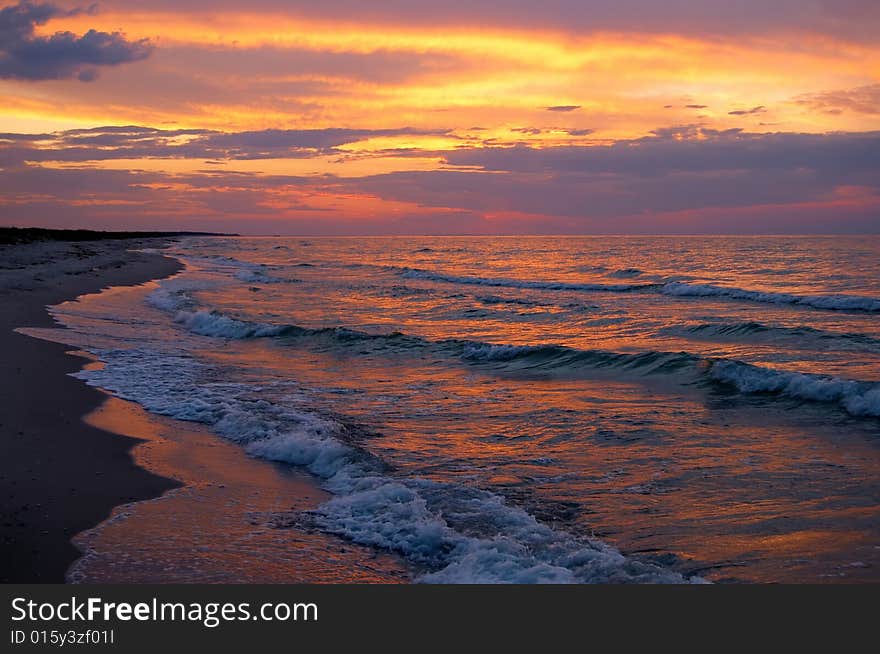 Sunset at seaside with waves