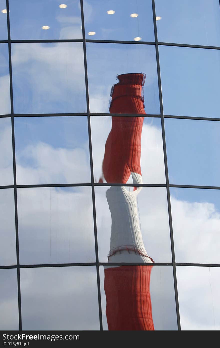 Pipe of Thermal Power Plant reflects from building's windows. Pipe of Thermal Power Plant reflects from building's windows