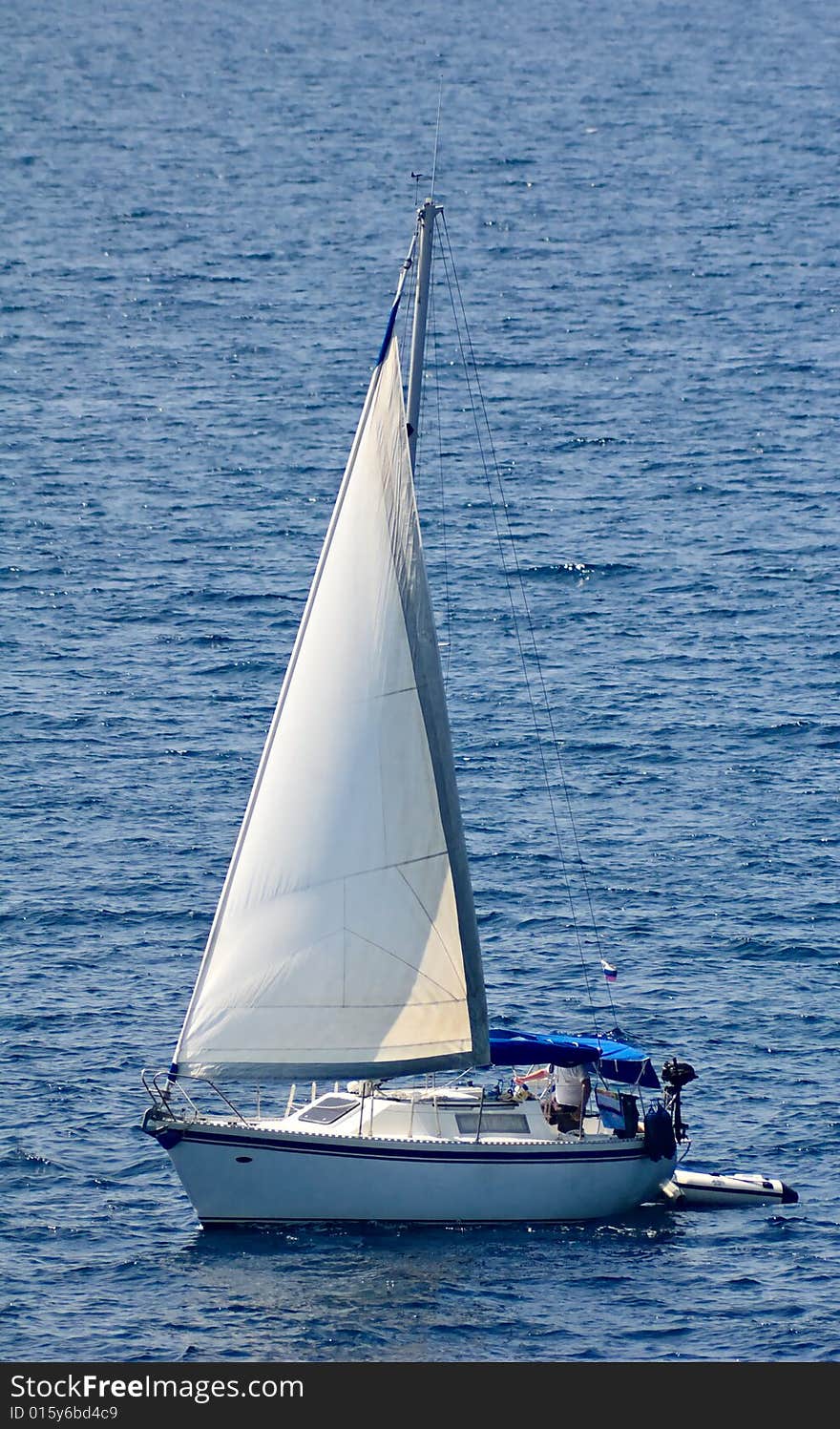 Photo of a yacht sailing in the Mediterranean sea. Photo of a yacht sailing in the Mediterranean sea