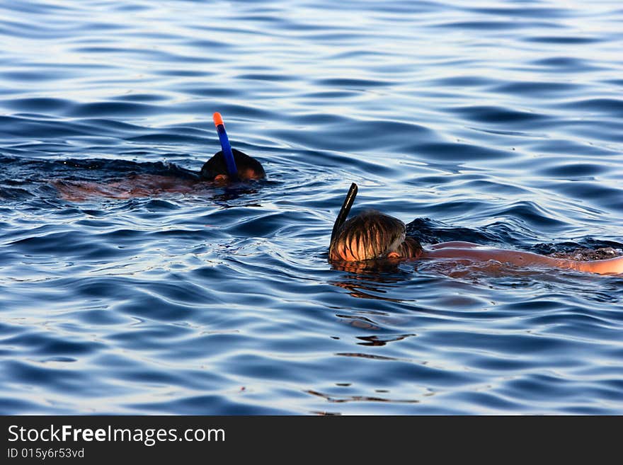 Two swimming man in the sea. Two swimming man in the sea.