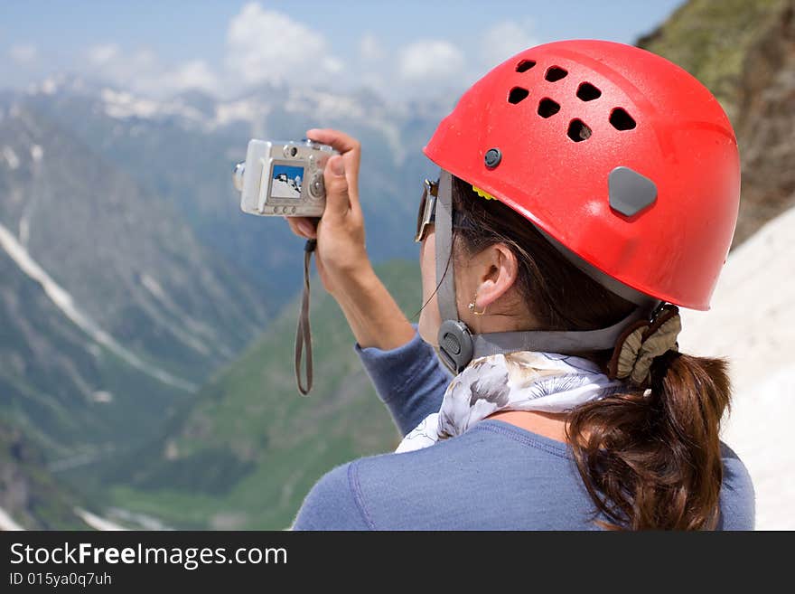 Girl making a photo in mountains