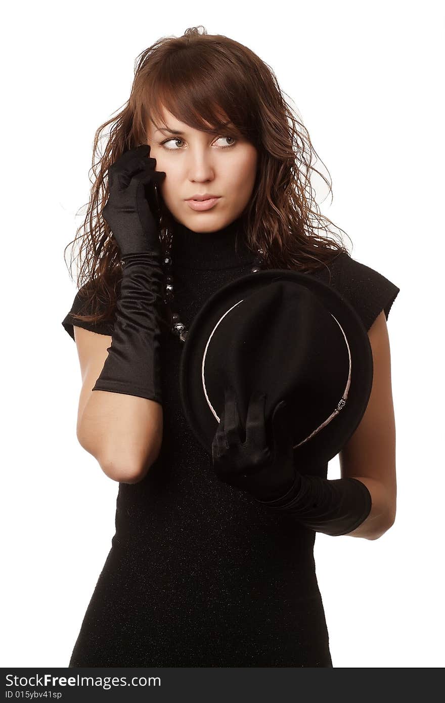 The girl in black clothes on a white background with a hat hat