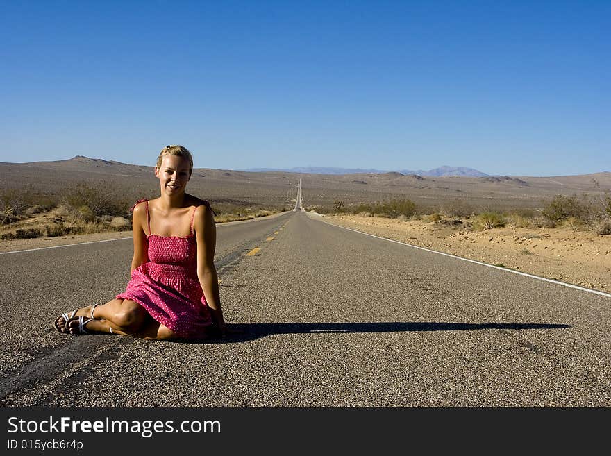 Woman sitting on the road