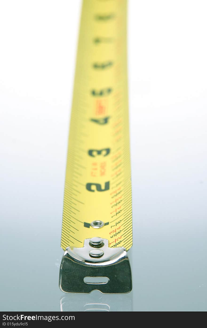 Protruding vertical tape measure tape against white