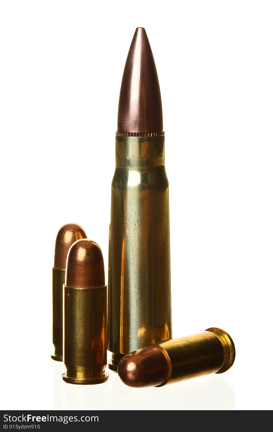 One Semi-automatic Rifle Bullet and Three smaller bullets, Isolated Against White Ground. One Semi-automatic Rifle Bullet and Three smaller bullets, Isolated Against White Ground