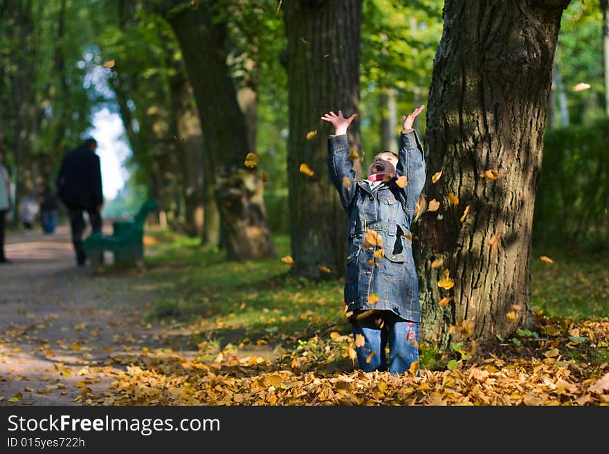 Girl and leaves at autumn