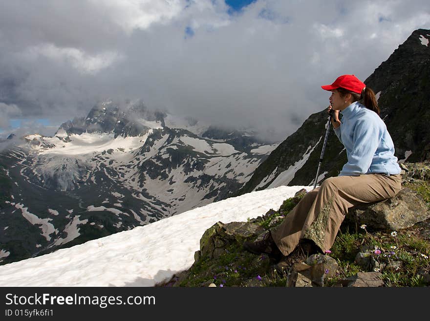 Hiker girl sitting on stone and looking to canyon. Hiker girl sitting on stone and looking to canyon