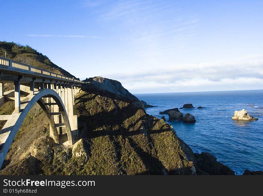 A bridge that is connecting to mountains. A bridge that is connecting to mountains