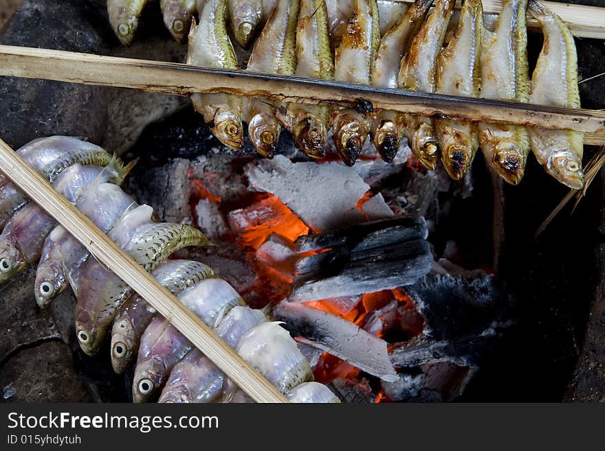 Fish grill with coal, with sticks fixed